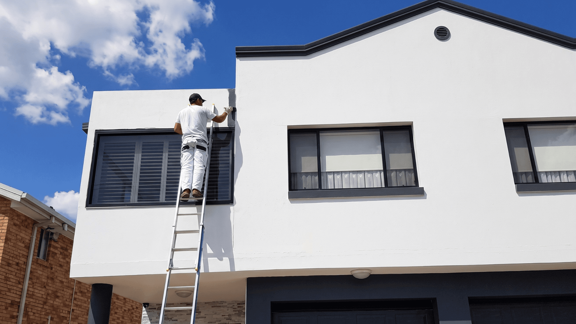 House exterior painting in progress including eaves and fascia