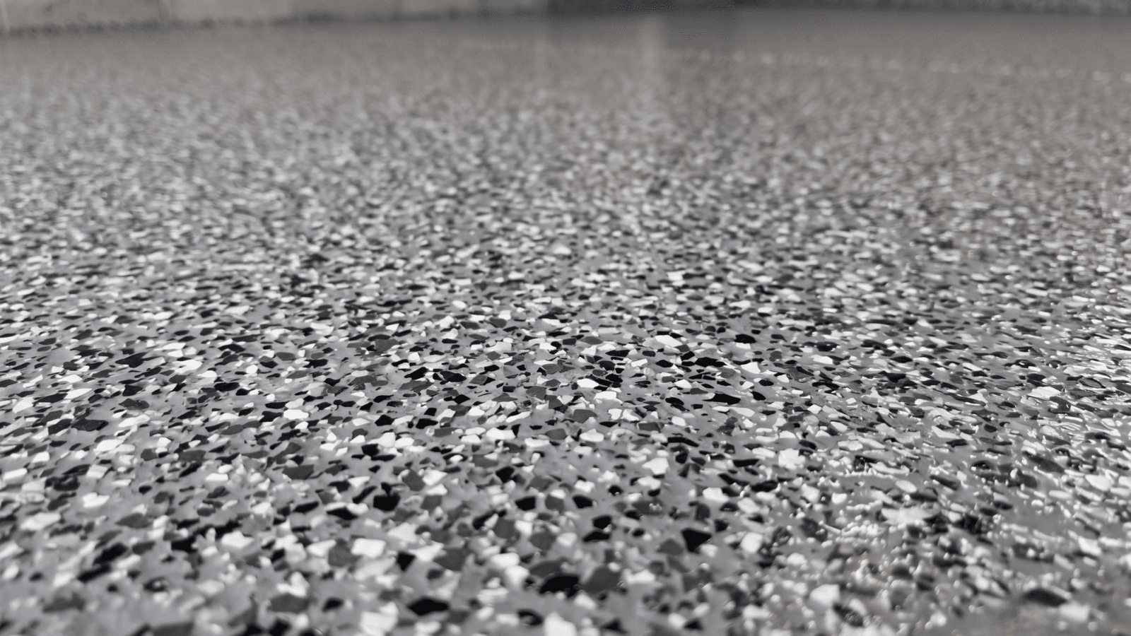 Epoxy flake floor coating close-up on a residential garage floor