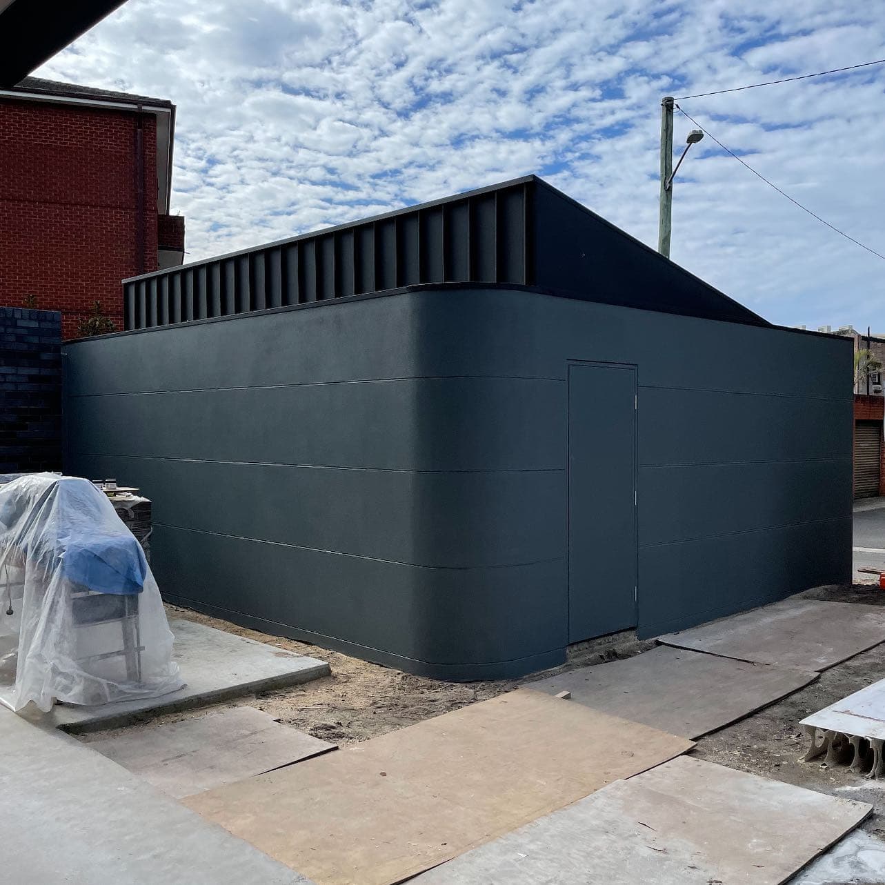 Rendered exterior home with a charcoal paint finish